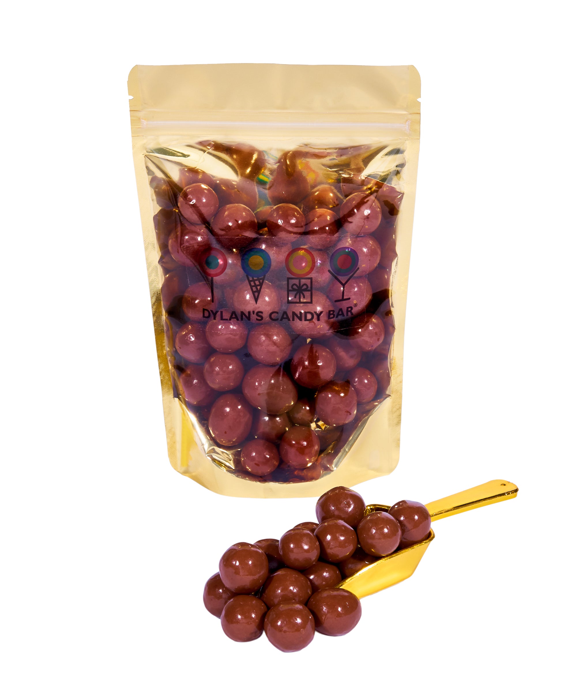 Milk Chocolate-Covered Brownie Batter Bites in resealable gold mylar bag next to Milk Chocolate-Covered Brownie Batter Bites overflowing from gold scoop