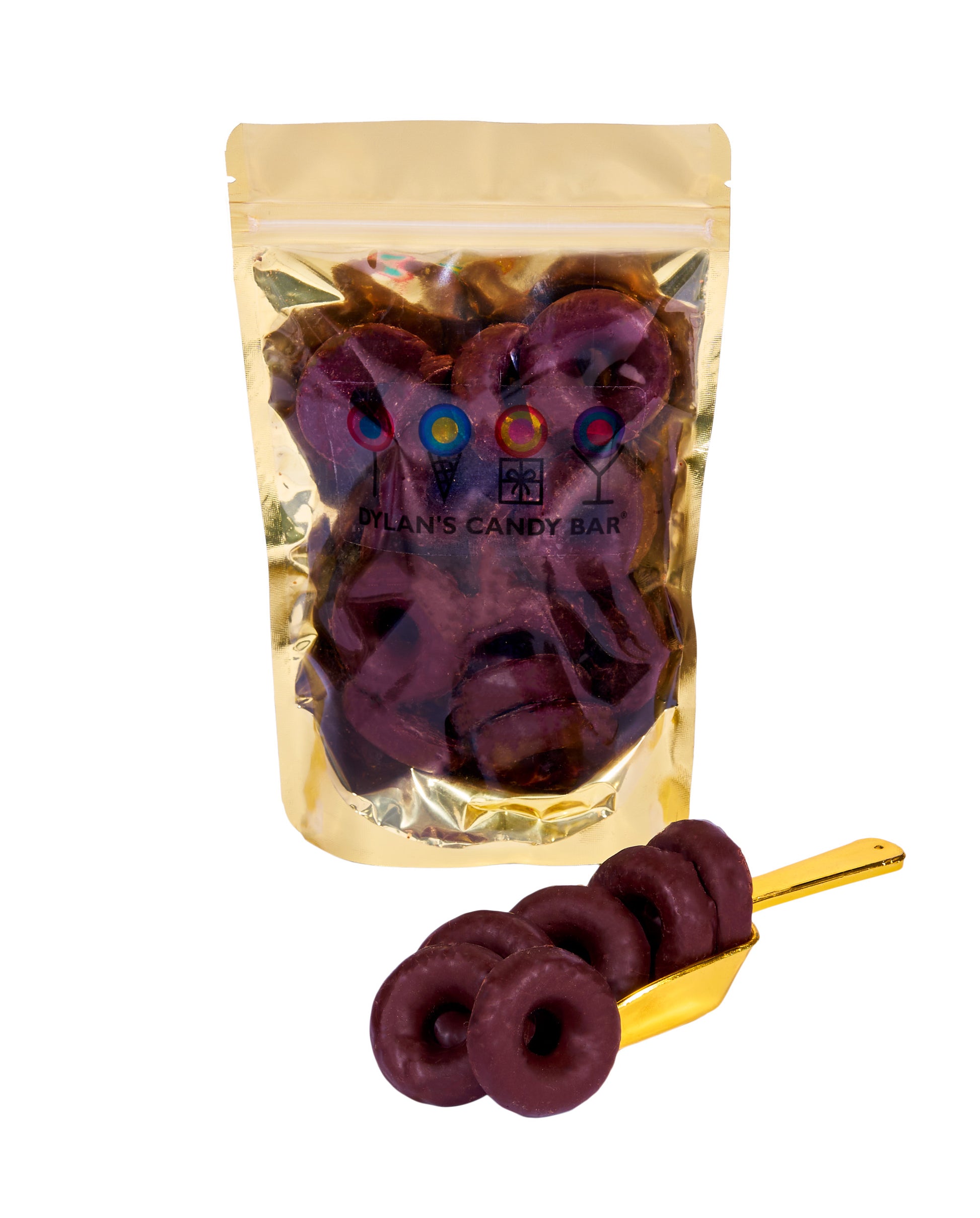 Dark Chocolate-Covered Raspberry Jelly Rings in resealable gold mylar bag next to Dark Chocolate-Covered Raspberry Jelly Rings overflowing from gold scoop